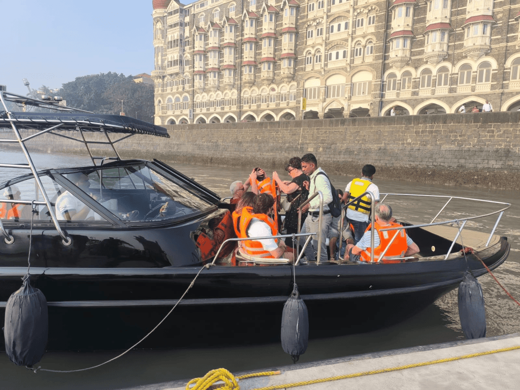 International guests boarding speedboat for Elephanta Caves tour by speedboat from Mumbai
